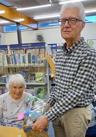 Handing the raffle winner her prize.
